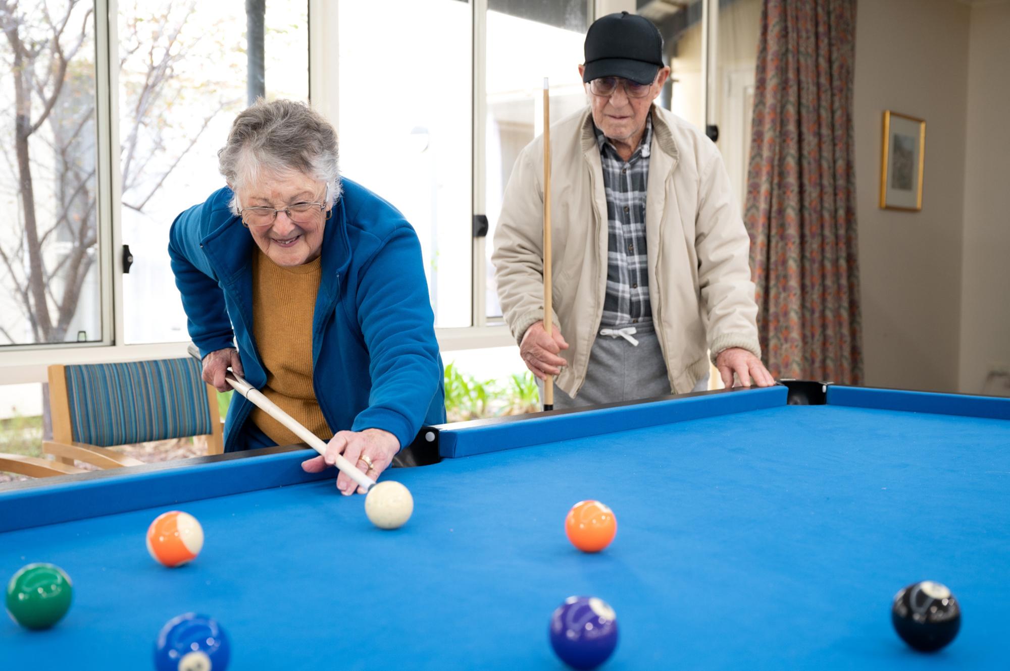 Bucklands Residential care lady playing pool 
