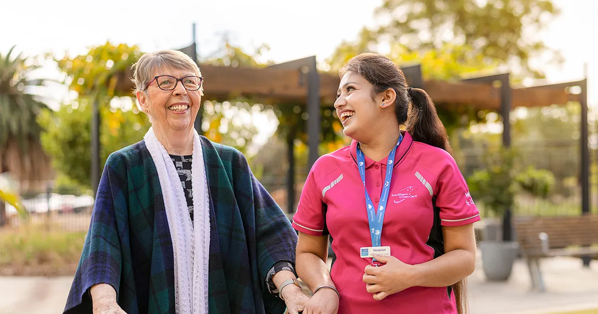 Southern Cross Care Female Lifestyle Staff Member and Female Resident Walking Together 