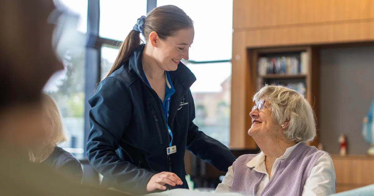 Southern Cross Care Female Occupational Therapist Chatting With Female Home Care Client.