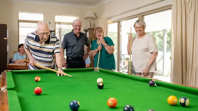 Residents Playing Billiards At Pine Springs Retirement Living