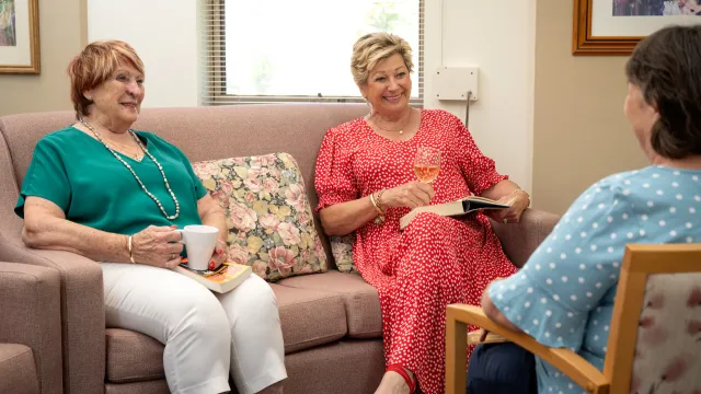 Three Female Residents Enjoying Drinks and Socialising At Pine Springs Retirement Village