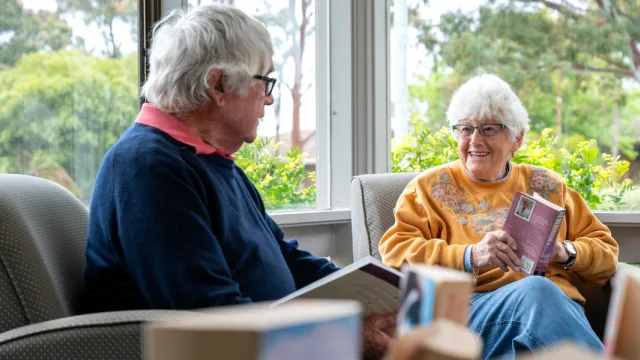 Female & Male Resident Reading Books Together At The Mornington Retirement Village