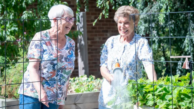 Residents In Community Garden At Pines Close Retirement Living