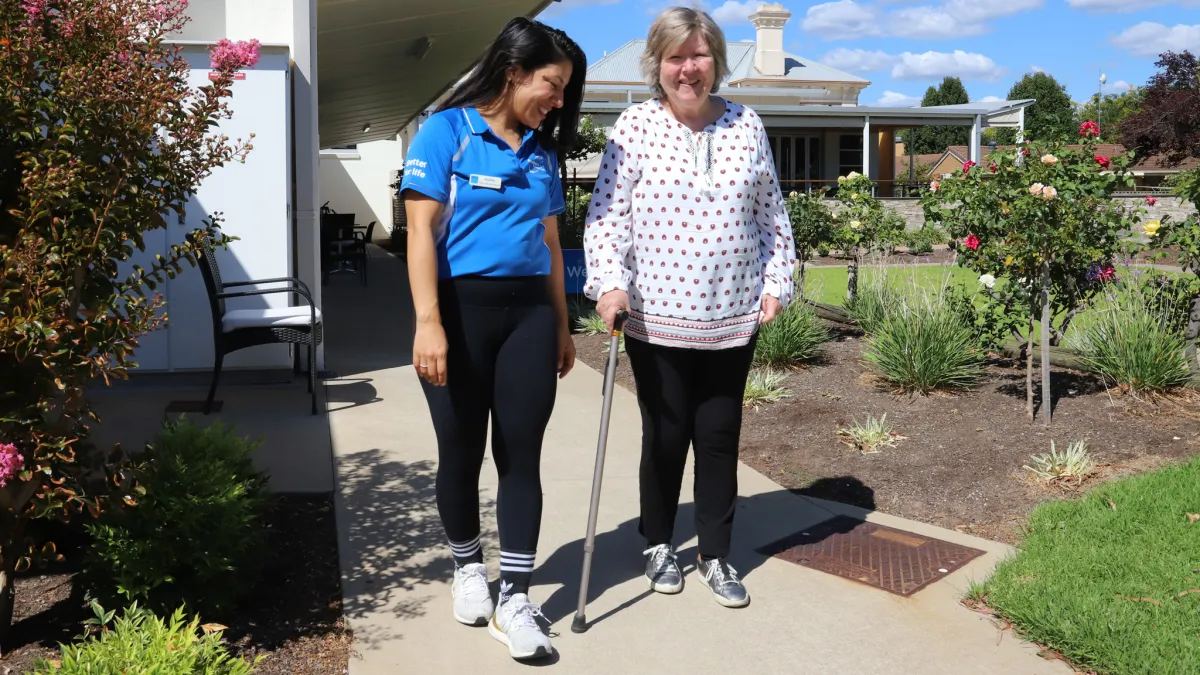 Health and Fitness Promoter Andrea Rosales watches Anne Mitchell walk