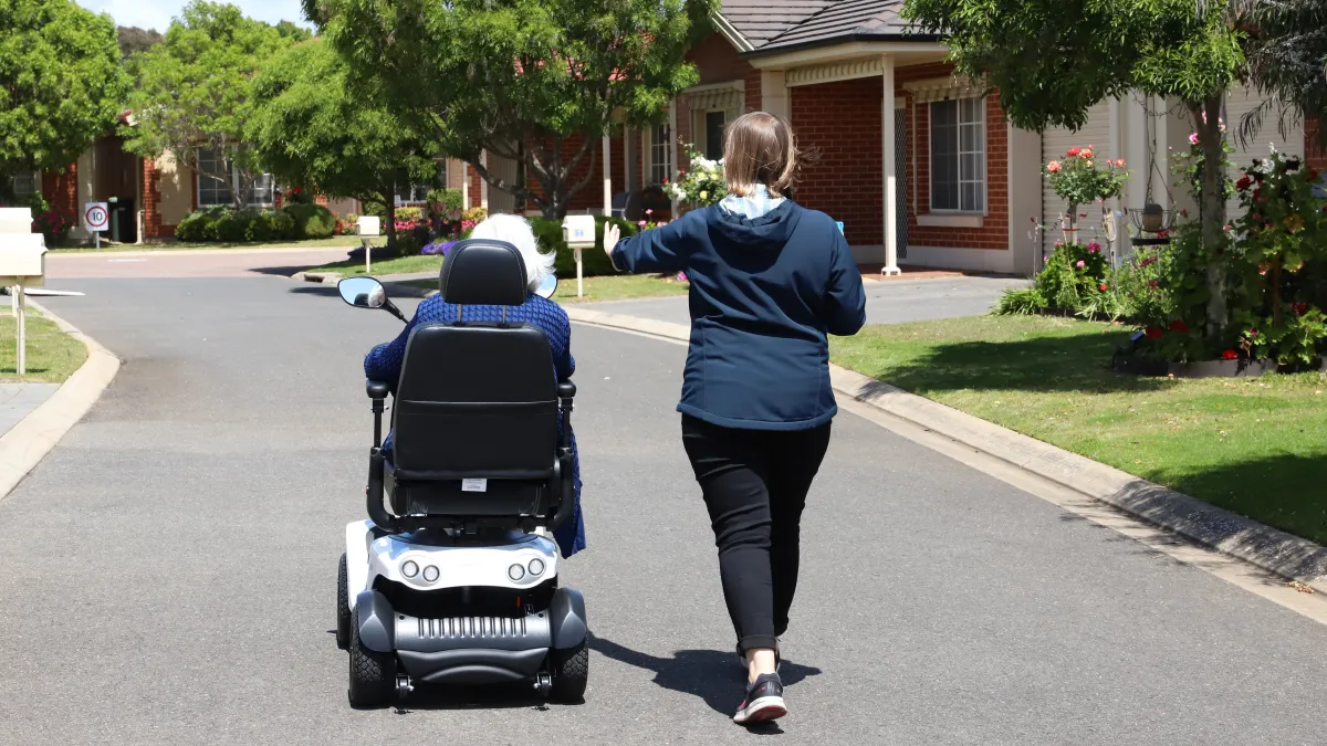 Occupational Therapist Tori Hunter leads a client in an electric mobility aid assessment