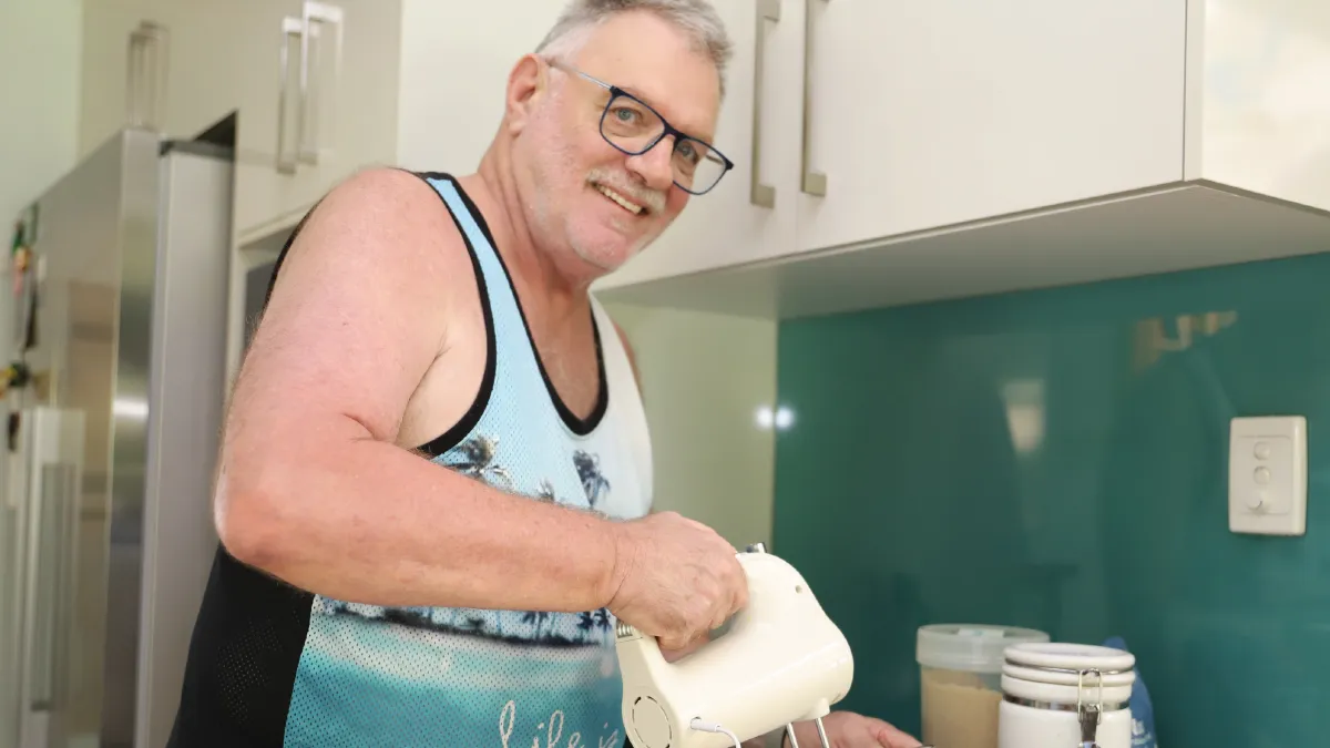 Home Care Client Cooking In Kitchen
