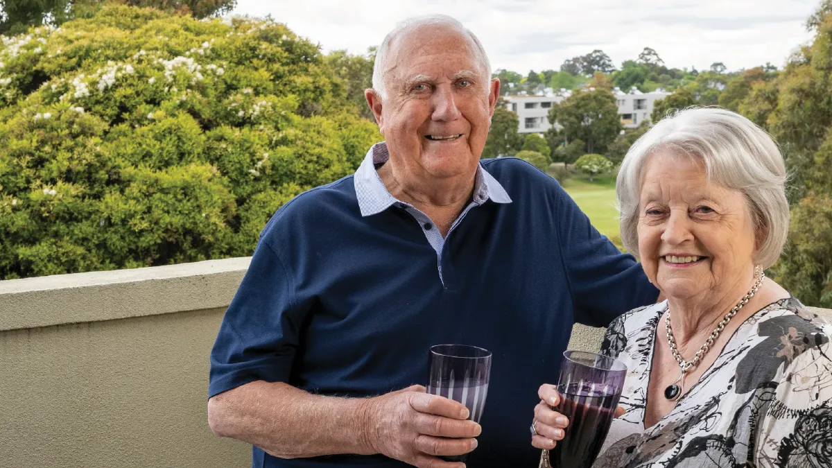 Barry Cameron and Ann enjoying drinks on a balcony