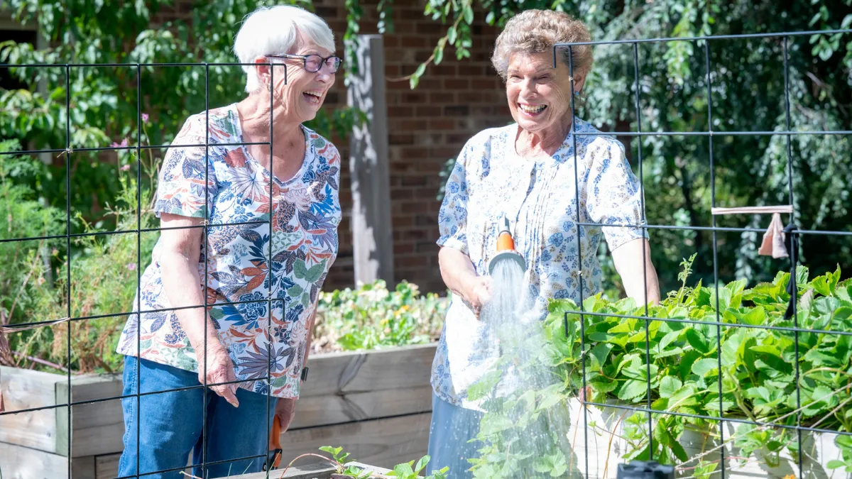 Retirement Living Residents Having A Chat In Community Garden
