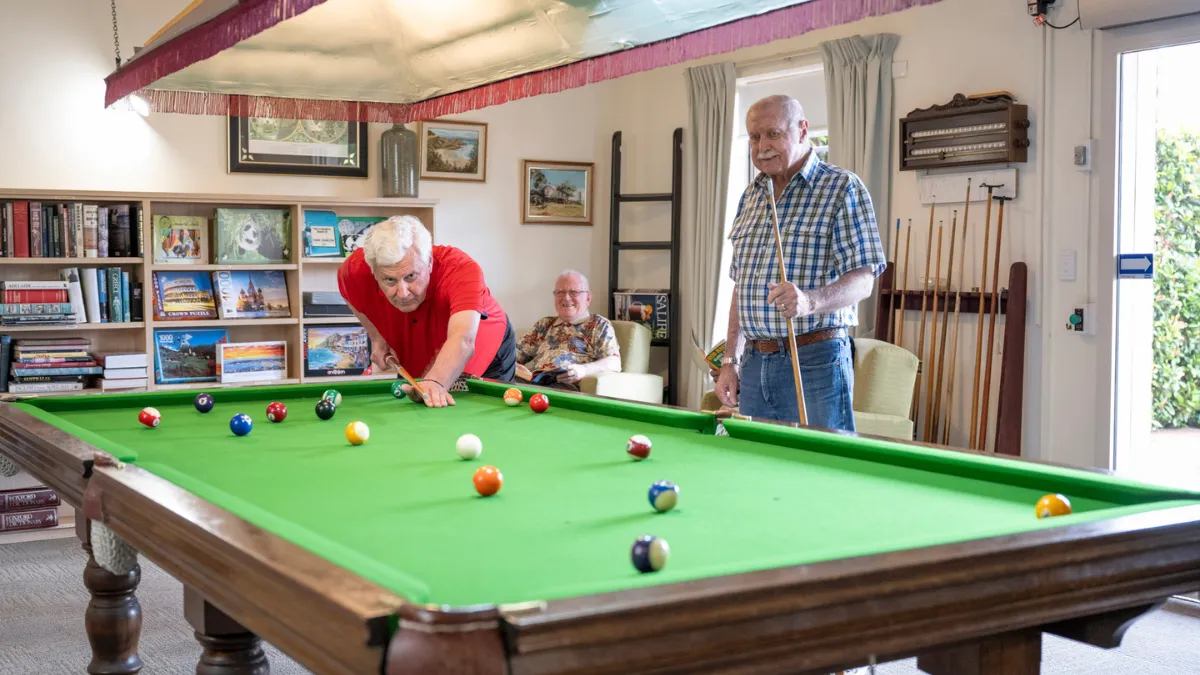 Three Male Residents Playing Pool 
