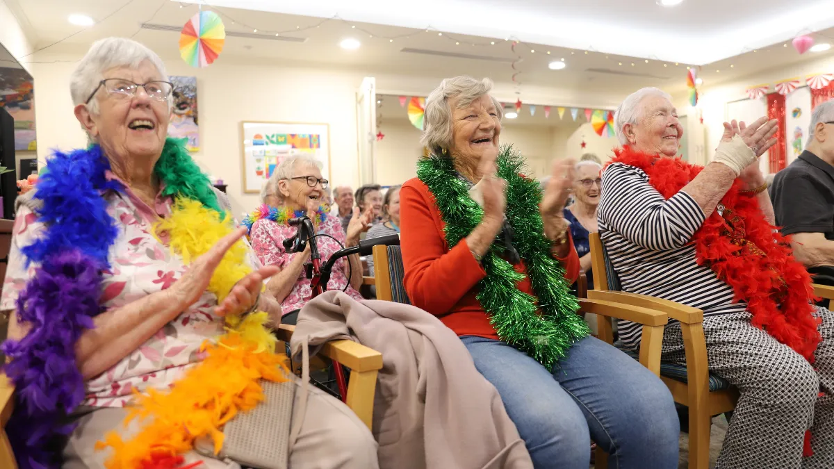 Residents clapping and smiling