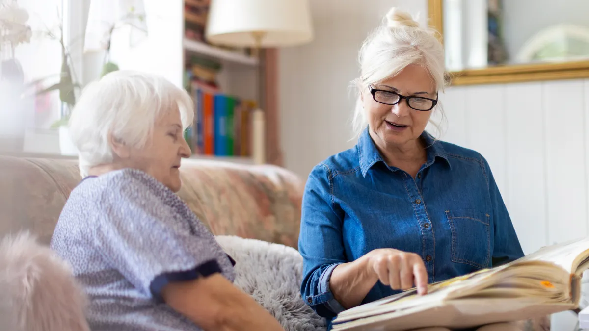 Two ladies looking over a book