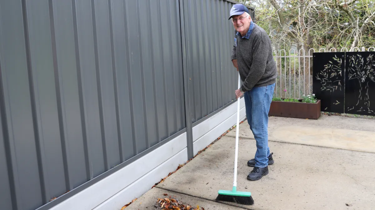 Jim Cannard sweeping leaves