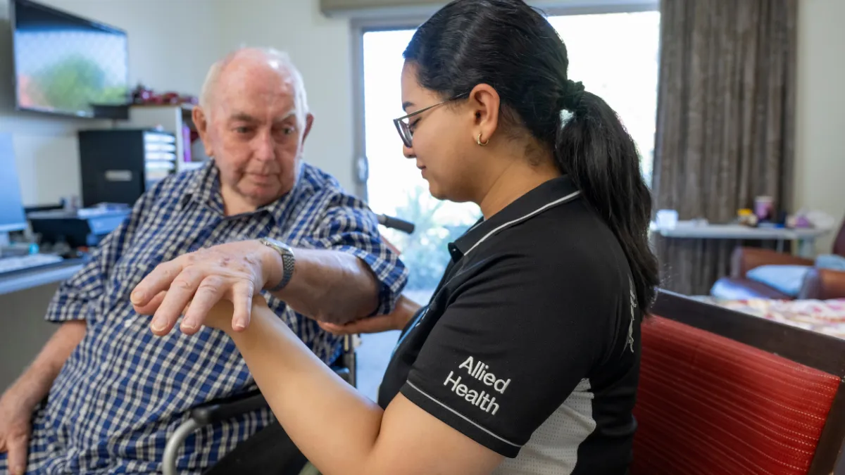 Allied health staff member working with a resident