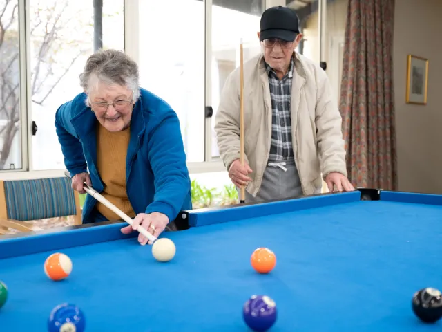 Bucklands Residential care lady playing pool 