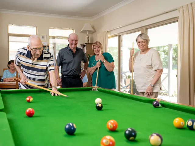 Residents Playing Billiards At Pine Springs Retirement Living