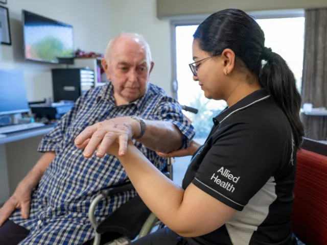 Allied health staff member working with a resident