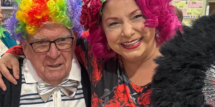 Female Performer and Male Resident Smiling For A Photo
