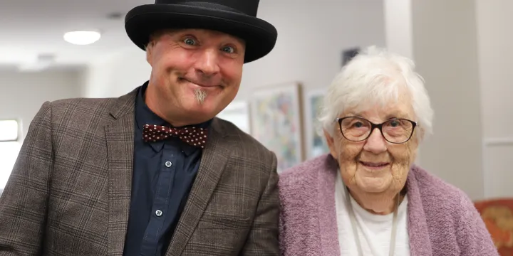 Male Performer and Female Resident Smiling For A Photo