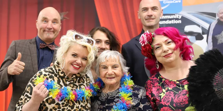 Rhythm & Motion performers and resident smiling for a photo