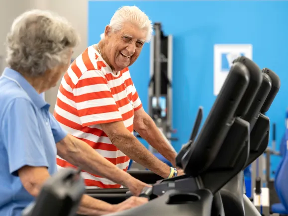 HF The Pines man and women on exercise equipment