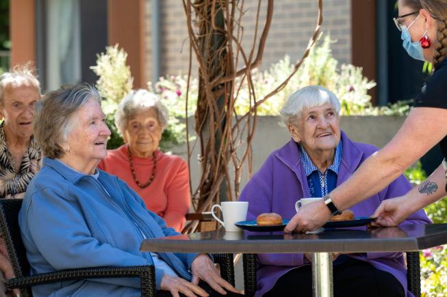 Oakfield Lodge Residential Care residents having afternoon tea outside