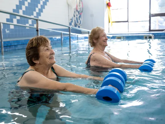 A group of female clients participating in an aqua fitness class