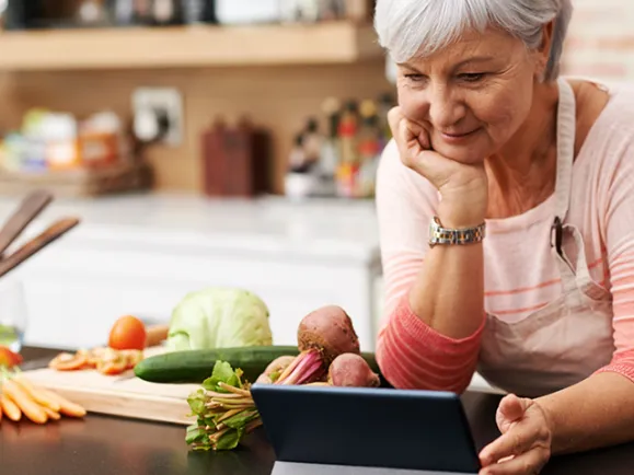 Female Reading Recipe From Laptop Screen In Kitchen - 640*480 - 6