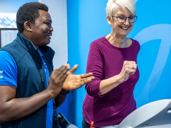 Personal Trainer Encouraging A Client During A Workout Session
