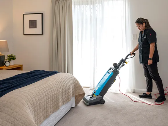 Cleaner Vacuuming At Glen Woodley Serviced Apartments