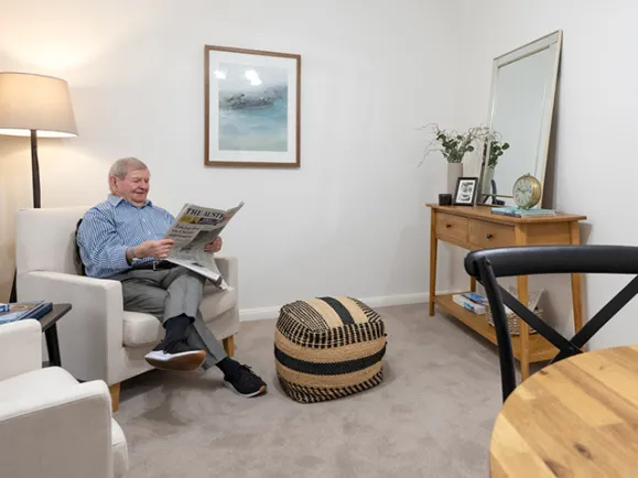Resident Reading Newspaper In Room At Glen Woodley Serviced Apartments 640x480