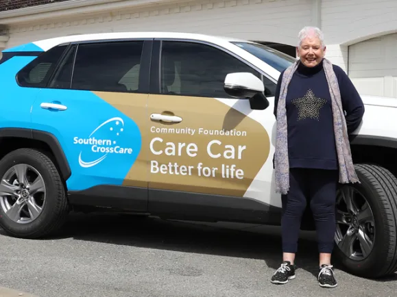 Volunteer in front of care care which is sponsored by community foundation
