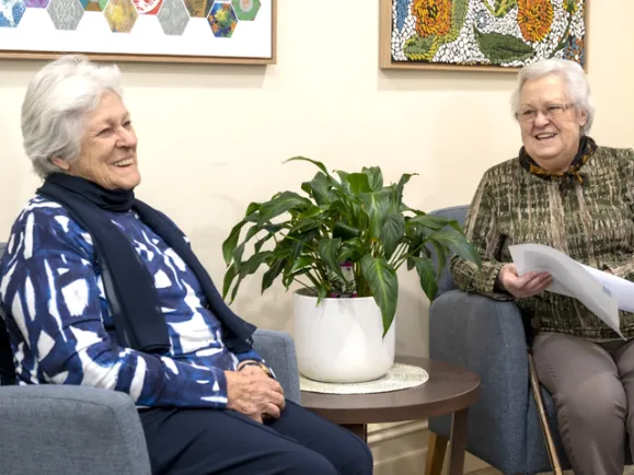 Two members of consumer advisory group sitting and chatting
