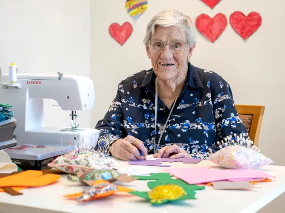 Female Resident Using Sewing Machine At The Oakfield Lodge Residential Care
