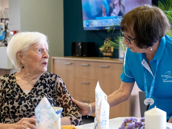 Female Resident and Volunteer Chatting At The Phillip Kennedy Centre Residential Care