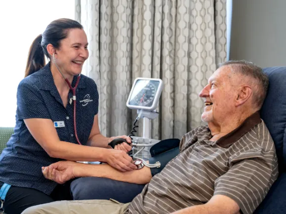 Registered Nurse Measuring A Resident's Blood Pressure At The Oakfield Lodge Residential Care
