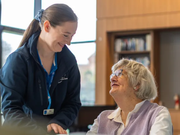 Southern Cross Care Female Occupational Therapist Doing Hand Exercises With Female Home Care Client
