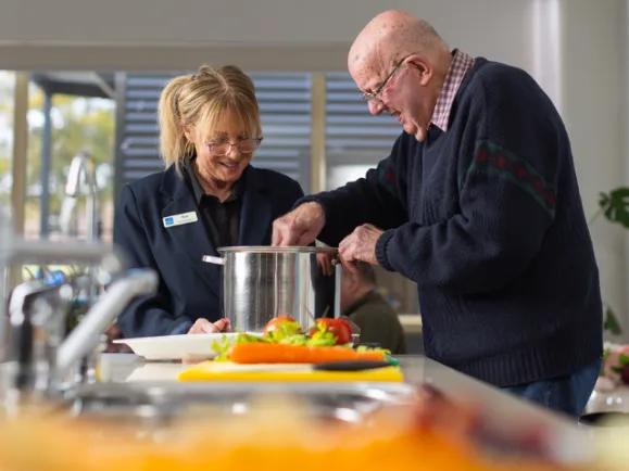  Name Southern Cross Care Female Respite Cottage Assistant and Male Respite Client Cooking Together At Myrtle Bank Respite Cottage