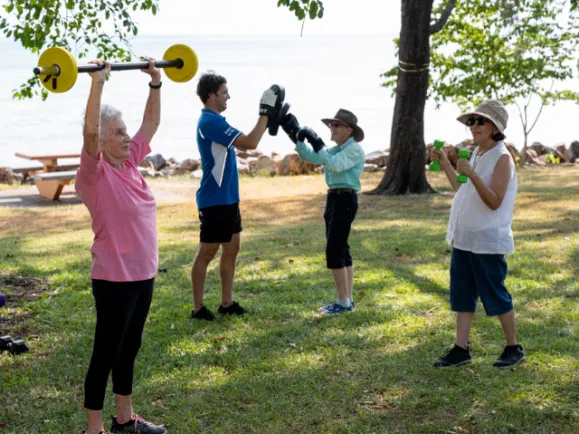Group of Clients Exercising Outside with Exercise Physiologist At Pearl Health & Fitness Centre