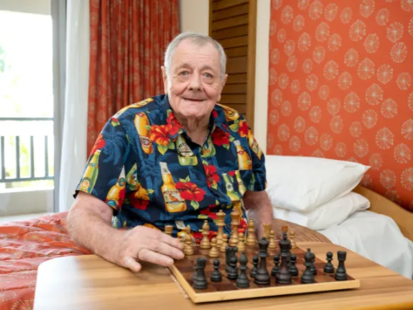 Male Resident Playing Chess At Pearl Supported Care