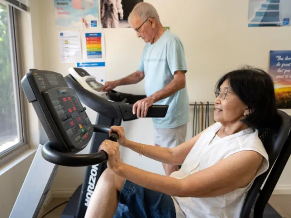 Male and Female Client on Exercise Machines At Pearl Health & Fitness Centre