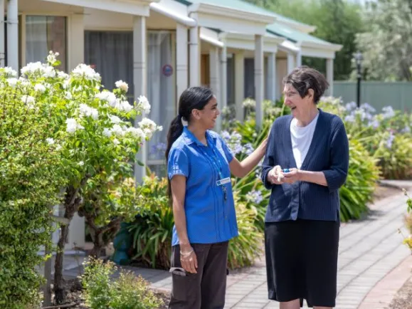 Resident and personal care worker in garden 