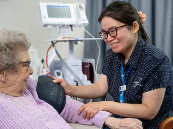 Resident with Regsitered Nurse getting blood pressure taken 