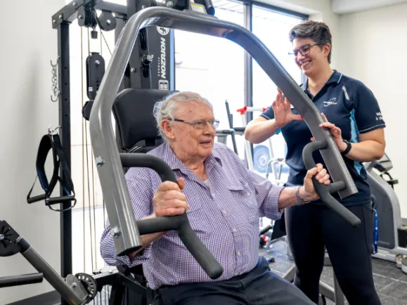 Male Resident On Exercise Machine At Mount Carmel Residential Care