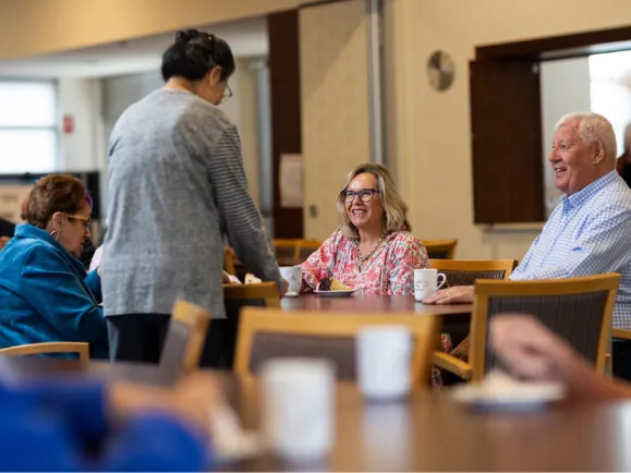 Residents In Community Centre At The Pines Retirement Living